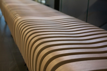 A close-up of a wooden bench in the shoppeng center.