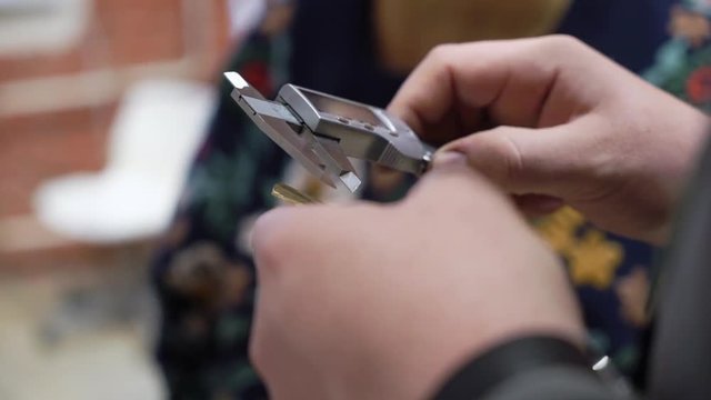 Jeweler makes a piece of jewelry - golden wedding ring