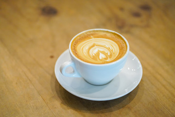 Cups of latte art on wooden table background, Top view.