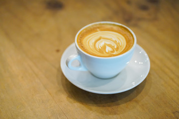 Cups of latte art on wooden table background, Top view.
