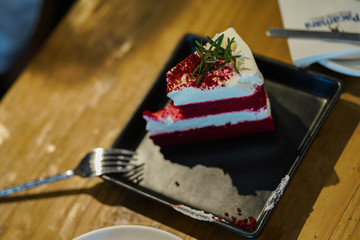 Strawberry cake was eaten place on dish and wooden background.