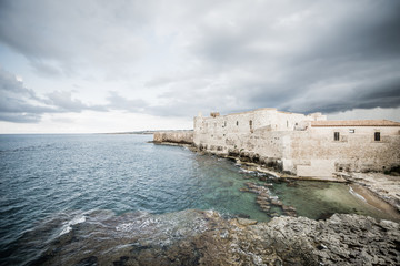 Fototapeta na wymiar Beautiful view of Maniace castle in Ortigia Syracuse, in front of the sea and sky.