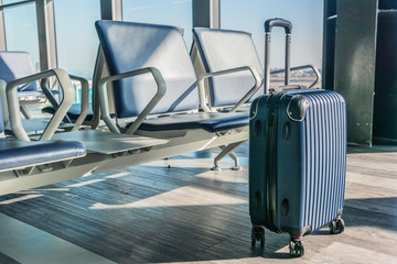 Plastic travel suitcase in the airport hall