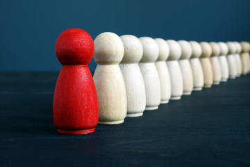 Hierarchy management and leadership concept. Being and the first. Red figurine ahead.