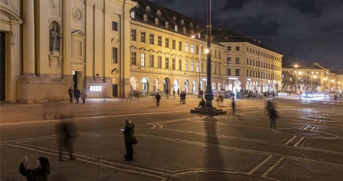 Timelapse video with people traffic at Odeonsplatz at night, Munich, Germany. View to the Theatine Church of St. Cajetan, a Catholic church in Munich.