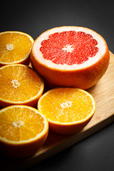 grapefruit and orange on wood background