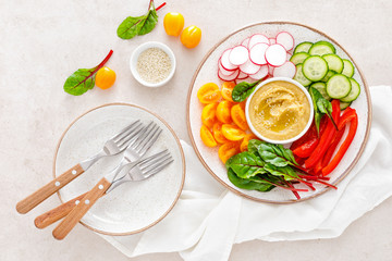 Vegetarian Buddha bowl with hummus and vegetables, top view