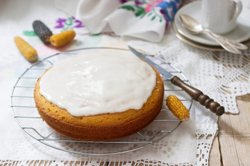 Traditional Romanian or Moldovan corn pie malay, with icing on a light background. Rustic style.