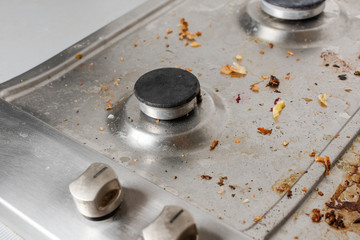 Dirty gas stove with food remnants