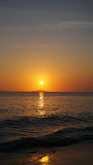 Bright sunset under the sea with yellow red gradient colors - Vertical