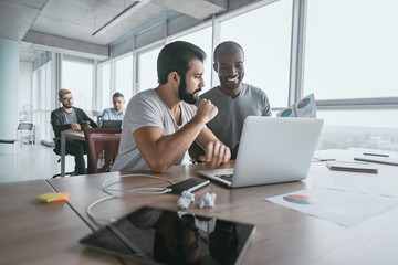 Two business colleagues discussing projects in modern office interior