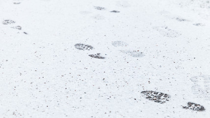 Human footprints over white snowy ground