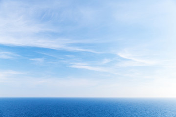 Naklejka na ściany i meble Blue sky background, clouds over ocean