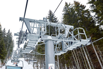 Ski lift at ski resort Bukovel in the mountains on a sunny winter day.
