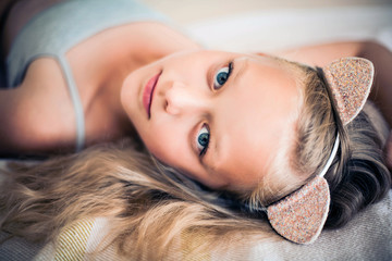 Portrait of pretty pre-teen girl wearing cat headband.