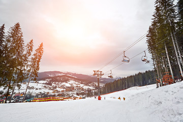 Ski lift at ski resort Bukovel in the mountains on a sunny winter day.