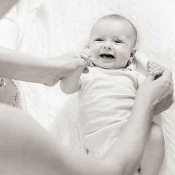 Closeup portrait of young mother with her cute newborn baby, black white image with bit toning