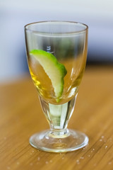 stack with lime slice on wooden table, close up, blurry background