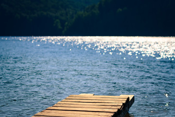 Fototapeta premium wooden pier on lake, blurred background, selective focus