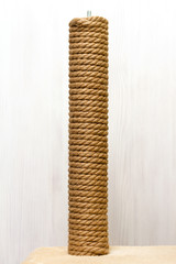 cat tree and furniture, sisal rope cat scratching post on beige carpet	