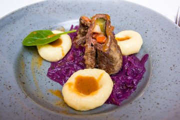 Beef roulade staffed with mushrooms in creamy mushroom sauce served with potatoes kluska.