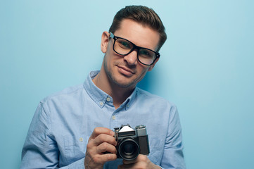 Young male photographer holding a new camera