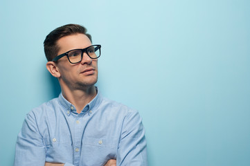 Young handsome businessman in formal wear and glasses