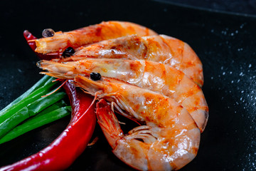 Grilled prawns with chili pepper. Royal delicious and beautiful shrimp. Flatley. Food background