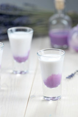 liqueur. Two glasses on a light wooden background. Close-up. Vertical frame orientation.