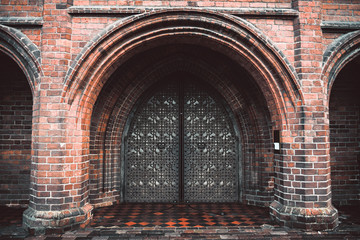 Arch entry door on red brick wall background