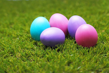 A bunch of colorful Easter eggs on green grass