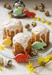 Easter composition of Easter cakes, biscuits, eggs and forsythia flowers. Rustic style.