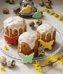 Easter composition of Easter cakes, biscuits, eggs and forsythia flowers. Rustic style.