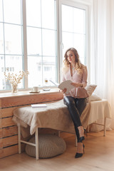Young business woman or imagemaker in cozy interior