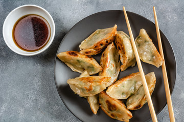 Fried dumplings Gyoza with shrimp filling and soy-ginger sauce.