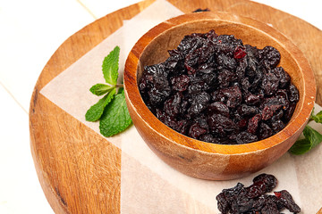 Dried grapes, raisins on wooden background. 