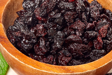 Dried grapes, raisins on wooden background. 