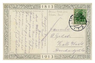 Fototapeta na wymiar Back of historical German postcard letter written in purple pencil, 100th anniversary of the battle of the Nations 1813-1913, with postage stamp and postmark, Germany