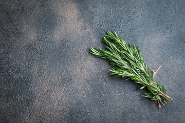 Fresh rosemary herb on a dark background copy space top view