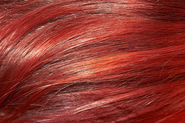 Red hair as background, texture. One of the popular shades of hair coloring