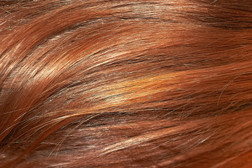 Red hair as background, texture. One of the popular shades of hair coloring