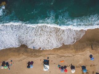 Beach with sun loungers on the coast of the ocean