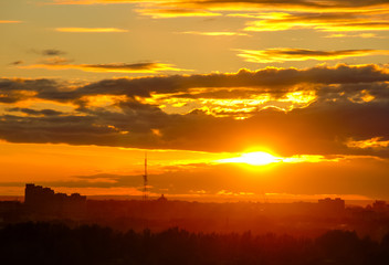 Beautiful city sunset with a sun and clouds 