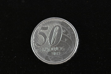 A super macro image of a fifty cent real coin isolated on a black background