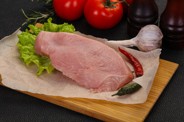 Raw Turkey steak served rosemary