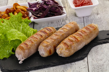 Grilled sausages served mushrooms and cabbage