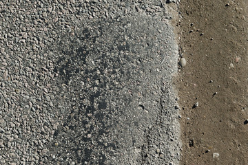 Road with a lot of cracked asphalt parts together next to ground