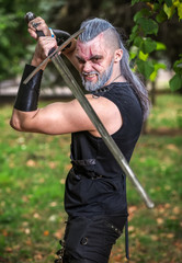 Cosplay character, Strong warrior with a sword in his hands. An angry hero, ready to attack