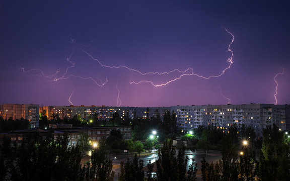 Lightning strikes down over the city at night. Beautiful shot. Long Exposure Photography