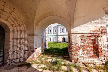 Arch passage in old church in center historical small town, ancient cobblestone and architecture buildings.